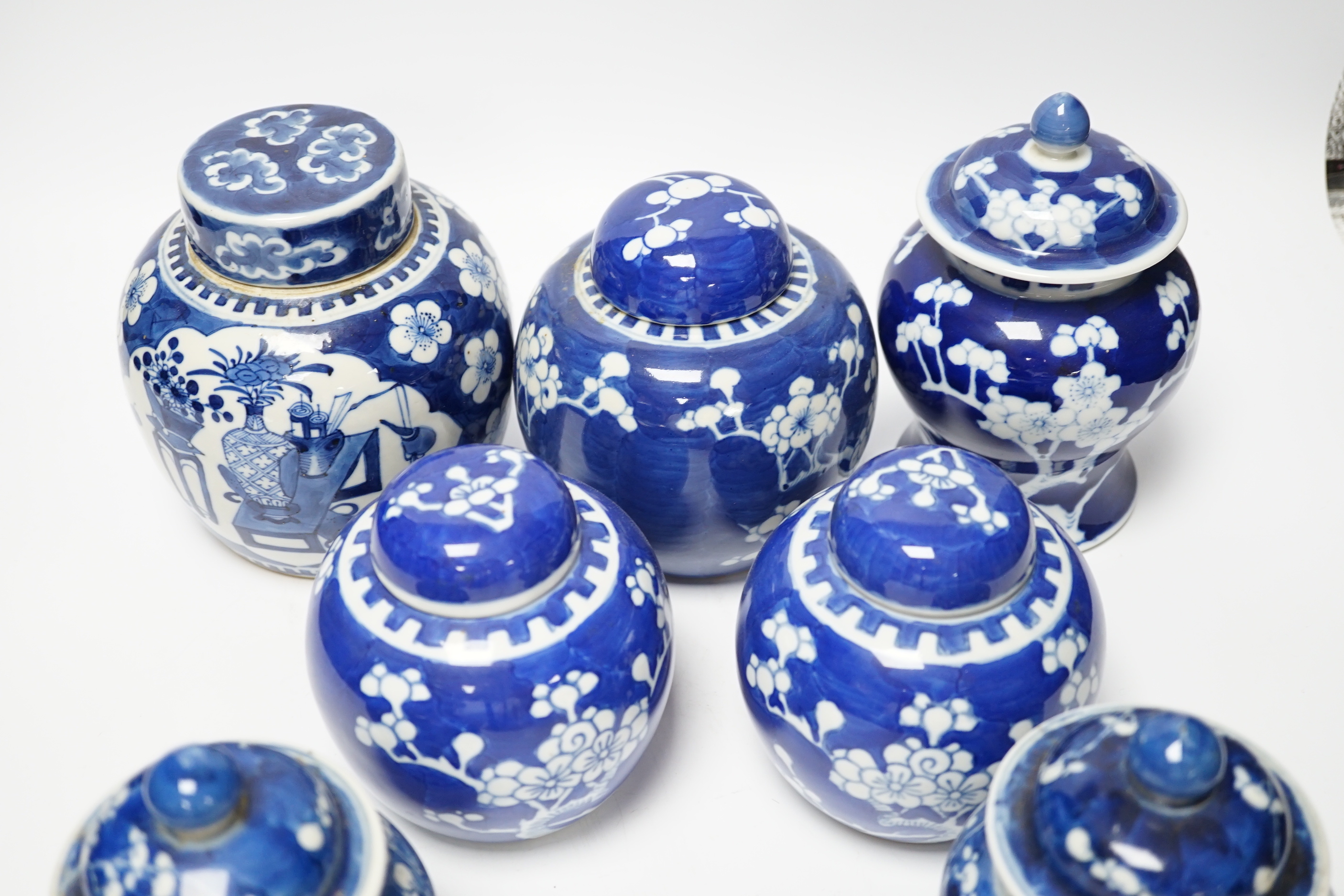 Seven Chinese blue and white Prunus decorated jars and covers, 19th/20th century, tallest 17cm high